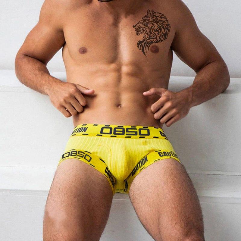 Daily wear|Gym sessions|Holiday parties|Pride events|Night gatherings|Breathable|Butt-lift design|Comfort|Proper support|Stylish appearance|Festive mood|Men's trunks|Low-rise underwear|Caution trunks|Sexy trunks|Yellow|Front view