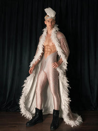 Three-quarter view of a male model wearing the white feather cape and headpiece set, showing the feather-trimmed opening and trailing hem