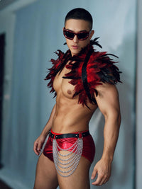 Three-quarter view of red and black feather male gogo costume with red briefs and waist chain