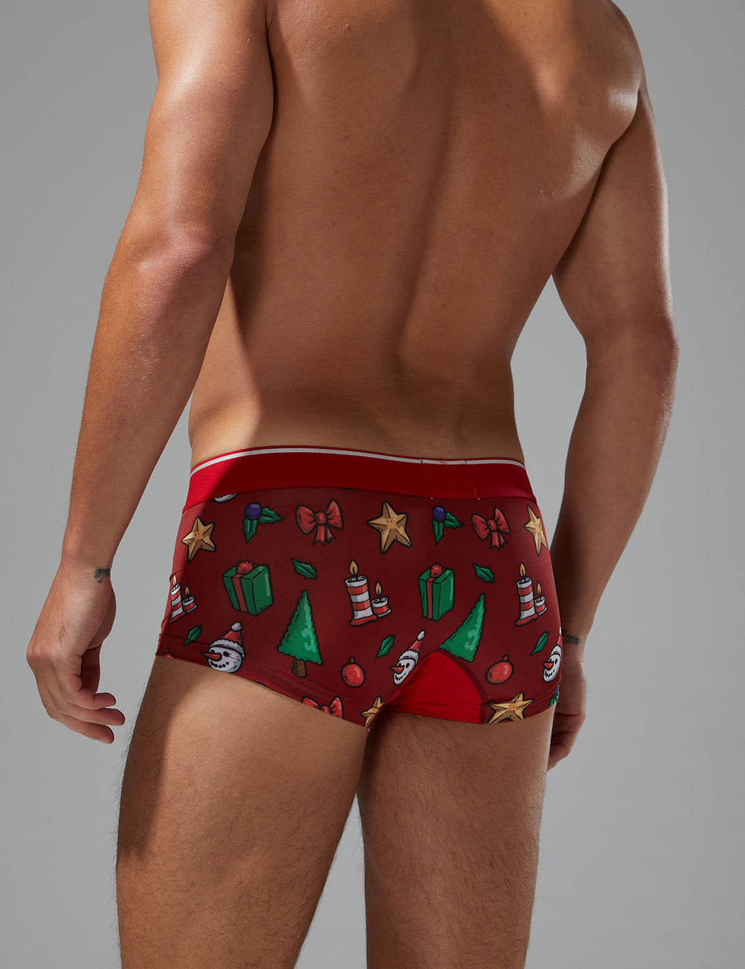 Daily wear|Gym sessions|Holiday parties|Pride events|Breathable|Butt-lift design|Snug fit|Lightweight|Comfort|Proper support|Stylish appearance|Festive mood|Men's trunks|Low-rise underwear|Polyester pouch trunks|Christmas collection underwear|Red|Back view